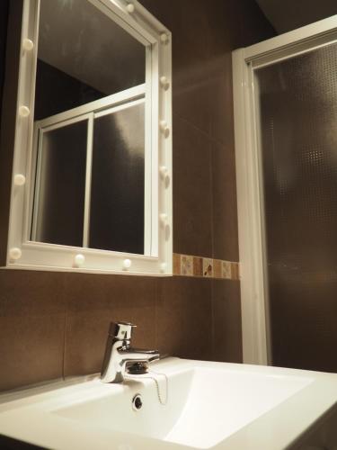 a bathroom sink with a mirror and a white sink at El Rincón de Anter C in Cenicientos