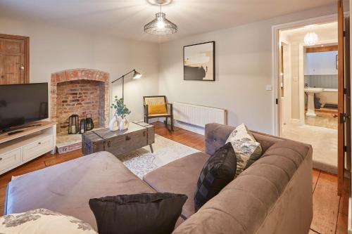a living room with a couch and a television at Host & Stay - Sleepers @ No.8 in Pickering