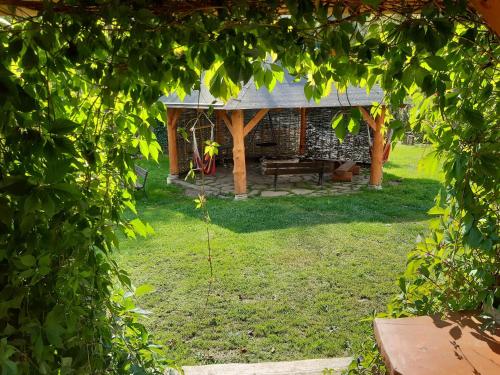 a garden with a bench and a stone building at PEGAZOWA WOLA CISNA in Cisna