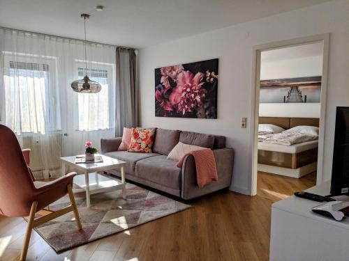 a living room with a couch and a bed at Cozy Apartment with Parking Garage near Outlet in Metzingen