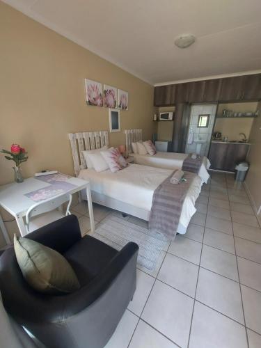 a living room with two beds and a couch at DeLutz Overnight Accommodation Room 2 in Polokwane