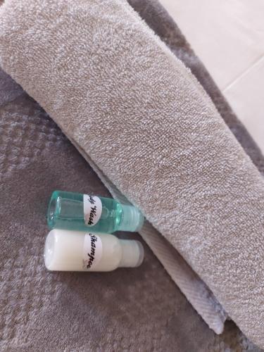 a pair of toothbrushes sitting next to a towel at DeLutz Overnight Accommodation Room 2 in Polokwane
