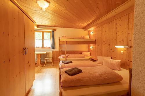 a room with three bunk beds in a cabin at Skihütte Zams in Zams