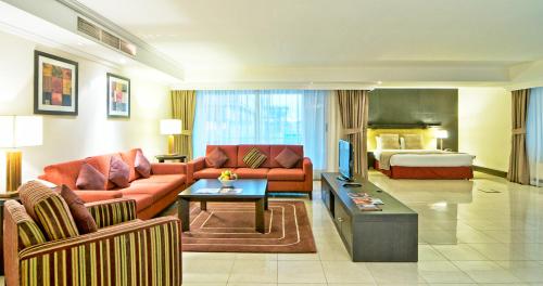 a living room with a couch and a bed at All Seasons Hotel Al Ain - Previously City Seasons in Al Ain
