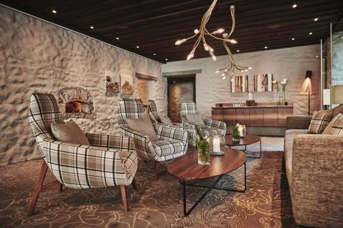 a living room with a bunch of chairs and a couch at 5th Floor Basic Rooms - shared bathrooms in Interlaken