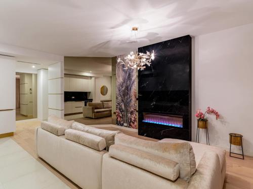 a living room with a couch and a fireplace at Vida Herastrau, luxury 2 rooms apartment in Bucharest