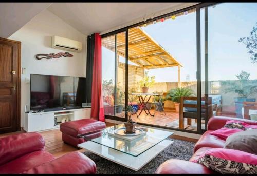 a living room with a couch and a glass table at Joshroom in Caux