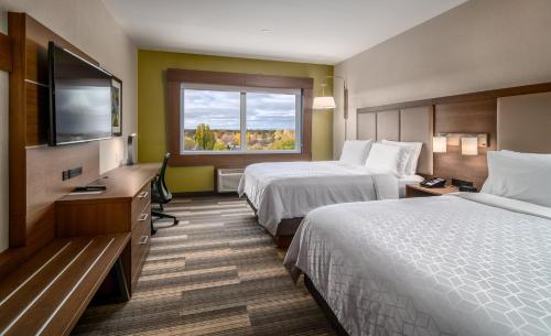 a hotel room with two beds and a flat screen tv at Holiday Inn Express & Suites - Brandon by IHG in Brandon