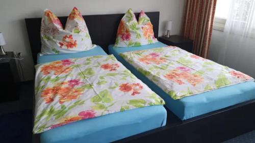 two beds with pillows on them in a room at priv. Apartment bei Swiss Holiday Park in Morschach