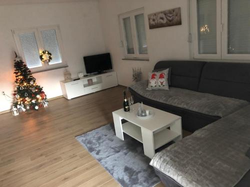 a living room with a christmas tree and a couch at Vikendica Bruše in Jaklići