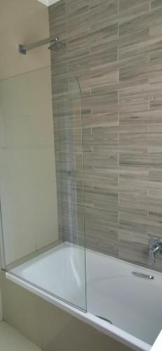 a shower with a glass door in a bathroom at 4 LA MER, BALLITO ON THE BEACH in Ballito