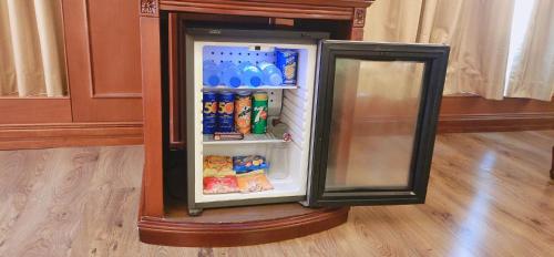 a refrigerator with a picture of a penguin on it at Riviera Hotel in Dubai