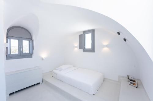 a white room with a bed and two windows at Philosophia Luxury Villa in Megalokhori