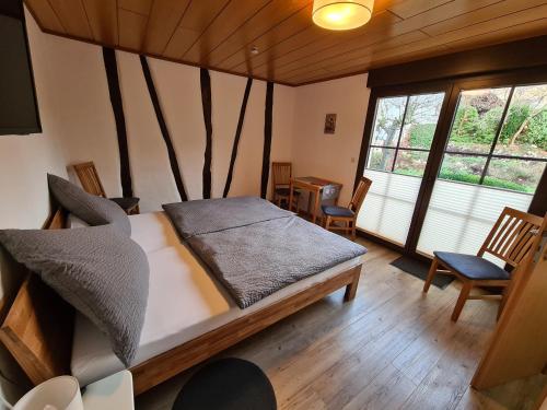 a bedroom with a bed and a table and chairs at Ferienhaus Winzerauszeit in Ellenz-Poltersdorf