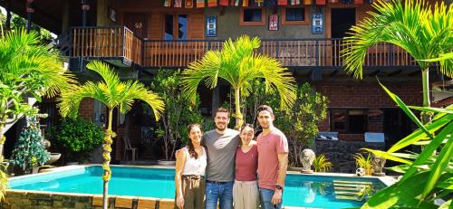 a group of people standing in front of a pool at Negombo The Nature Villa and Cabanas in Negombo