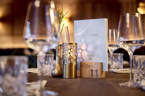 a table topped with glasses and bottles of wine at Hotel Neue Post in Mayrhofen