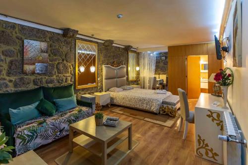 a living room with a couch and a bed in a room at Quinta Sao Miguel de Arcos in Vila do Conde
