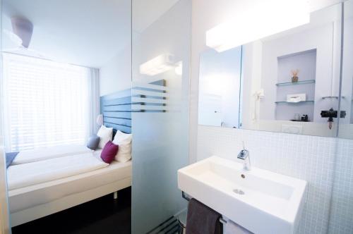 a bathroom with a sink and a mirror at Sky Design Motel in Kriessern