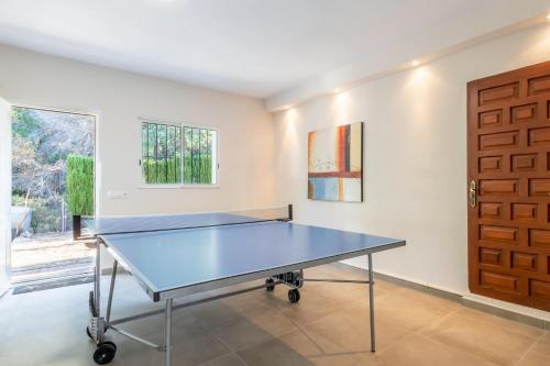 a ping pong table in a room with a door at Fantastisic villa - Great location in Moraira