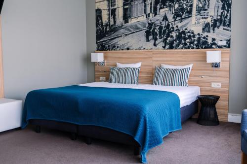 Postel nebo postele na pokoji v ubytování Stadshotel De Klok