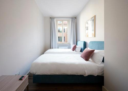 a bedroom with a large bed and a window at Numa Milan Loreto in Milan