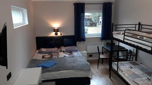 a room with two bunk beds and a window at Pokoje, apartament NA WYSPIE in Gdańsk