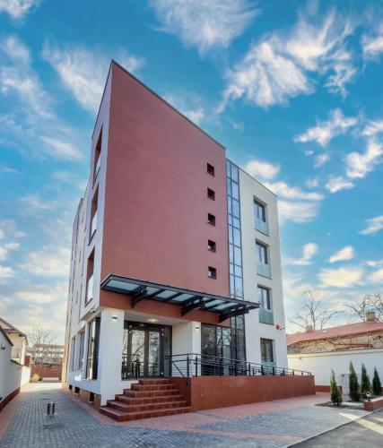 a large white building with a red at Signature Aparthotel - Boutique in Galaţi