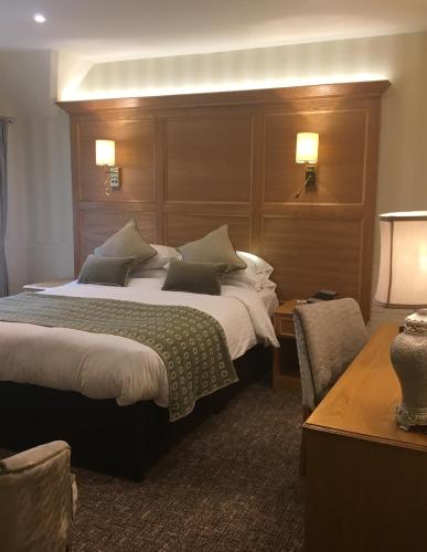 a hotel room with two beds and a table at Royal Oak Hotel in Betws-y-coed