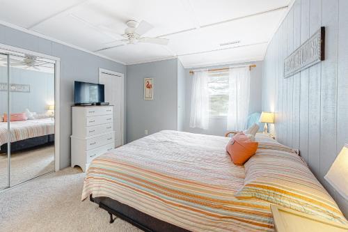 a bedroom with a large bed and a television at Mallard Lakes -- 38287 Cardinal #139 in Selbyville