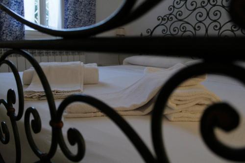 a bed with white sheets and towels on it at Appartamento Redentore in Venice