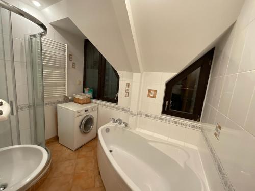 a bathroom with a tub and a toilet and a sink at Tatry Fimali in Vysoke Tatry - Tatranska Lomnica.