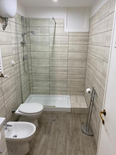 a bathroom with a shower and a toilet and a sink at Guest's Heaven in Rome