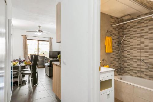 a kitchen and dining room with a tub and a table at Panoramic 2 Bed Penthouse in Los Cristianos