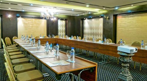 a large dining room with tables and chairs in it at All Seasons Hotel Al Ain - Previously City Seasons in Al Ain