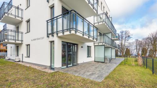 an exterior view of a white building with balconies at Nexo, Sun & Snow in Puck