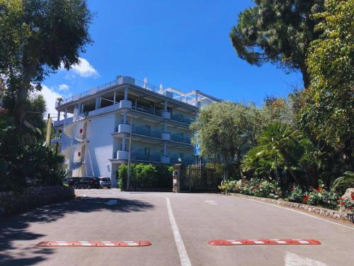 a road with red and white barriers in front of a building at Village Camping Santa Fortunata - Campogaio in Sorrento