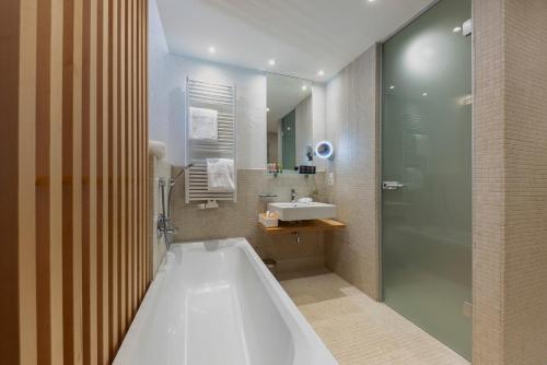 W łazience znajduje się wanna, umywalka i prysznic. w obiekcie MALI by m3 w mieście Sankt Anton am Arlberg