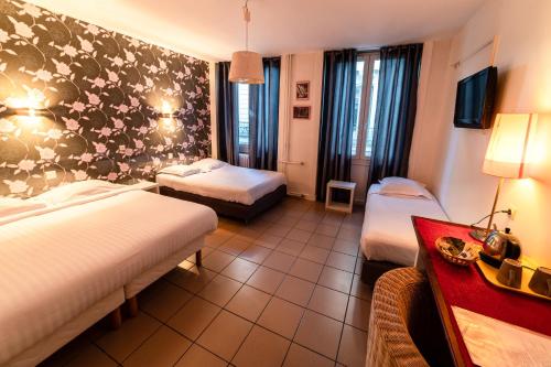 Postel nebo postele na pokoji v ubytování Hôtel Furania