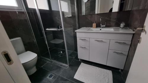 a bathroom with a shower and a sink and a toilet at KING of the dead sea by CROWN in Neve Zohar