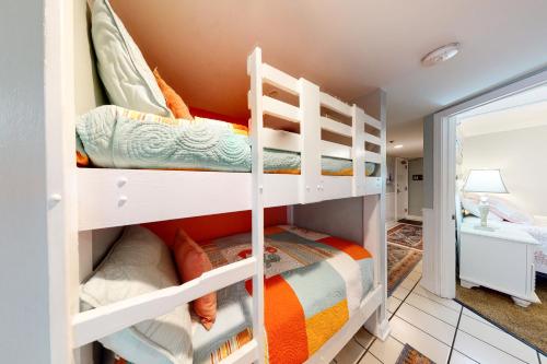 a bedroom with two bunk beds and a bathroom at Clearwater II in Gulf Shores