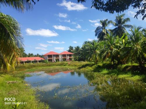 a resort with a pond in front of it at Hotel Exotica Squares in Neil Island