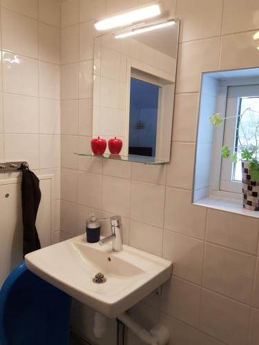 Baño blanco con lavabo y espejo en StugaFalun, en Falun