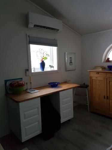a kitchen with a wooden counter with a window at StugaFalun in Falun