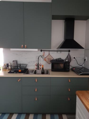 a kitchen with a sink and a microwave at StugaFalun in Falun