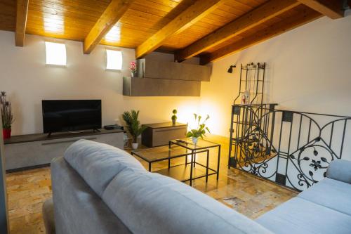 a living room with a couch and a tv at B&B Palazzo Storico Di Nicola in Pescara