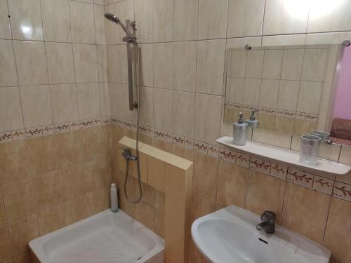 a bathroom with a sink and a toilet and a mirror at Готель-Маєток in Luts'k