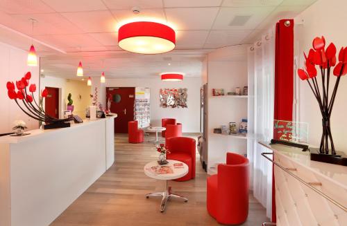 a kitchen filled with furniture and a red light at The Originals City, Hôtel Loval, Brest (Inter-Hotel) in Brest