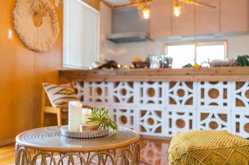 a kitchen with a table and chairs and a counter at SEA VIEW HOUSE KIRA KIRA HINANO in Nanjo
