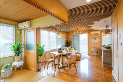 a living room with a table and chairs at SEA VIEW HOUSE KIRA KIRA HINANO in Nanjo