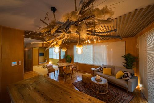 a living room with a couch and a table at SEA VIEW HOUSE KIRA KIRA HINANO in Nanjo